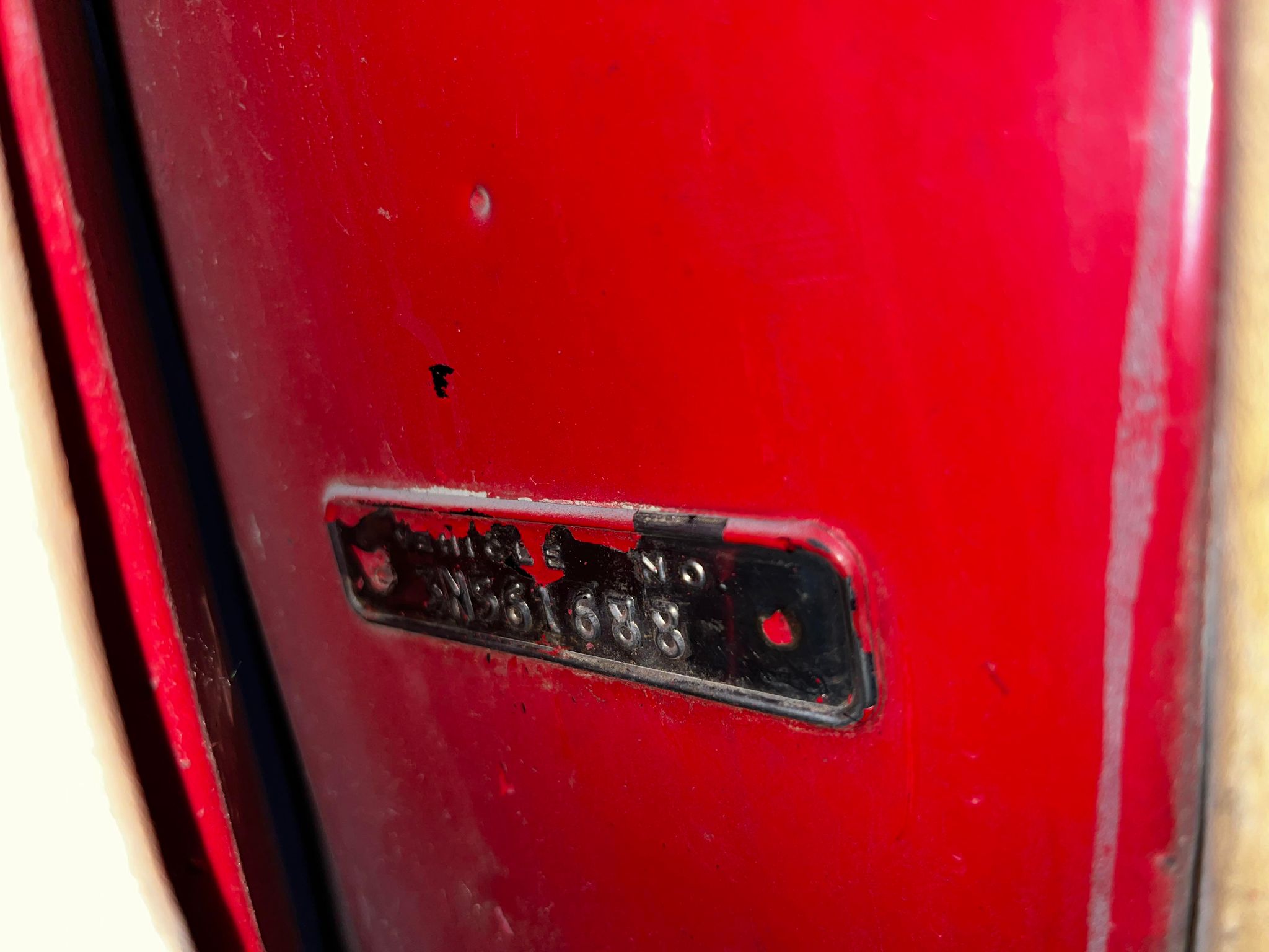 A close-up of a red mailbox
Description automatically generated