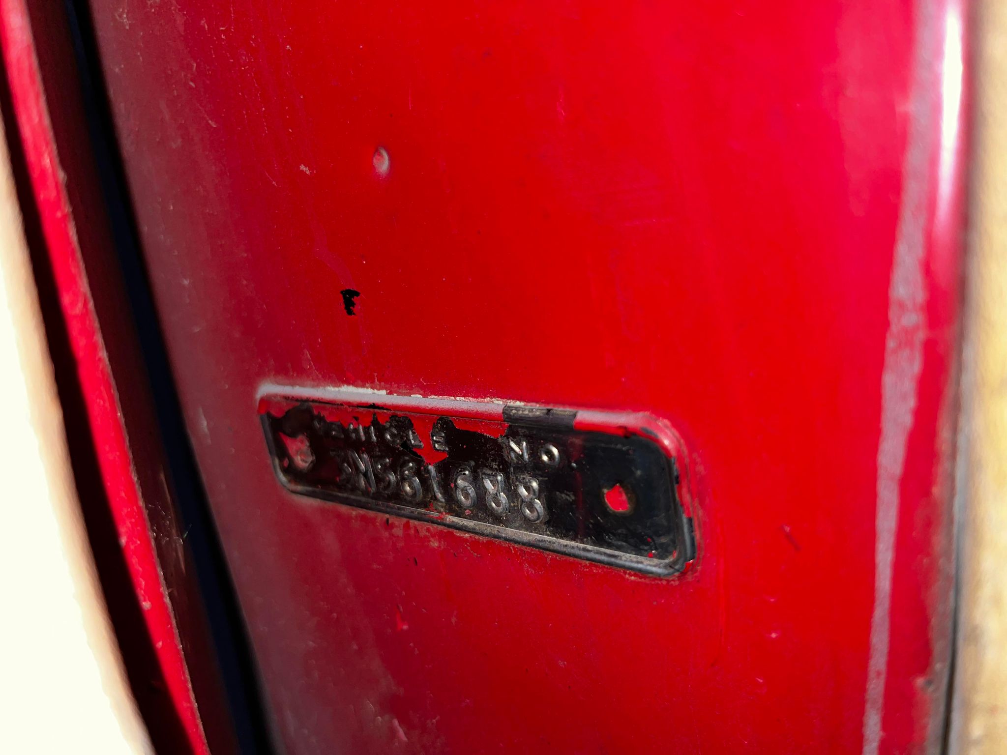 A close-up of a red mailbox

Description automatically generated